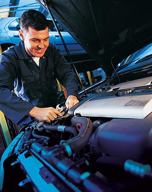 Professional Vehicle Technician under the hood of a car